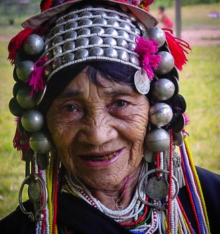 akha elderwoman wearing traditional headpiece